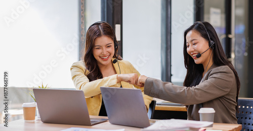 Fotografie Customer support, women and employees with headset, office and working late with new system or above