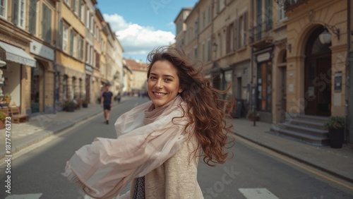 Candid-style shot of a woman crossing a charming old town street, light scarf and hair moving with the wind. Natural motion, lifestyle photography vibe, European travel feeling.