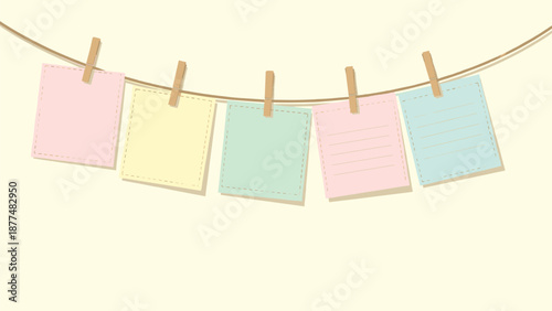 Five colorful blank square sticky notes in pastel shades hang from a brown twine clothesline with small wooden clothespins.