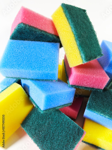 Closeup, isolated pile of rectangular, colorful scouring sponges for cleaning chores.