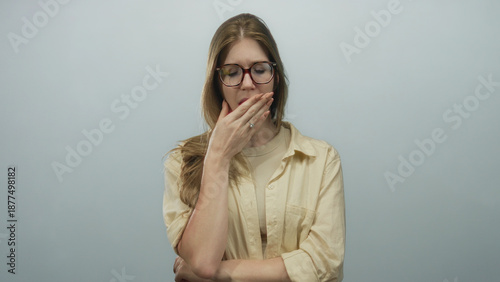 Schilderij op canvas Woman yawning with glasses and bare neck in pale gray studio setting, head tilted back in tired pose; fatigue