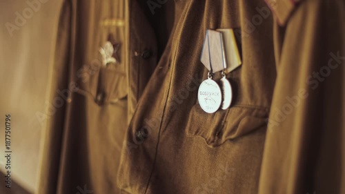 Close up detail view of Soviet military uniform, khaki fabric, shoulder straps of Red Army lieutenant, medals are on breast pocket, historical uniform from World War Two