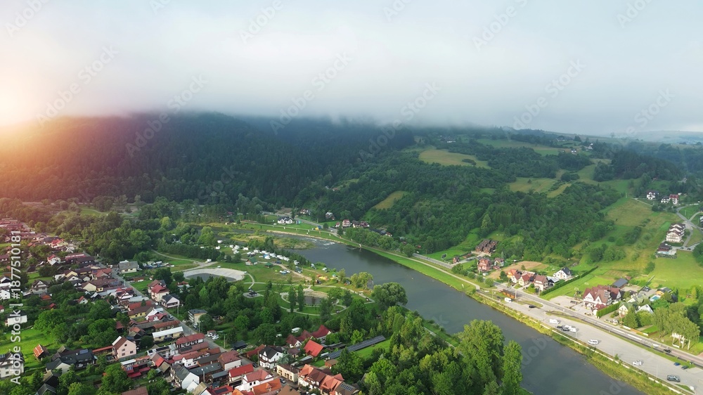 Fototapeta premium Rural mountain scenery with grasslands and forest mist