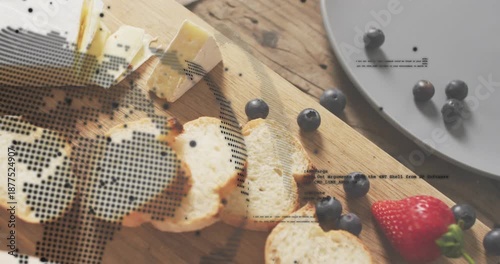 Circular overlay sweeping board scanning cheese wedge bread berries strawberry, revealing code text