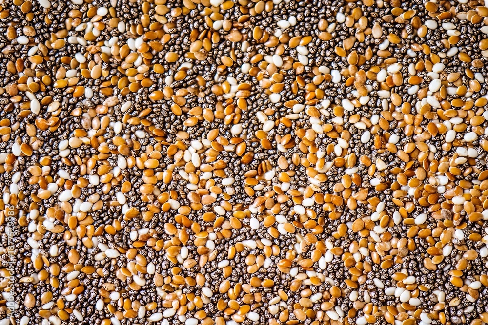 Fototapeta premium Chia and flax seeds macro texture with organic pattern, showcasing a vibrant mix of colors and shapes in a natural setting for culinary use
