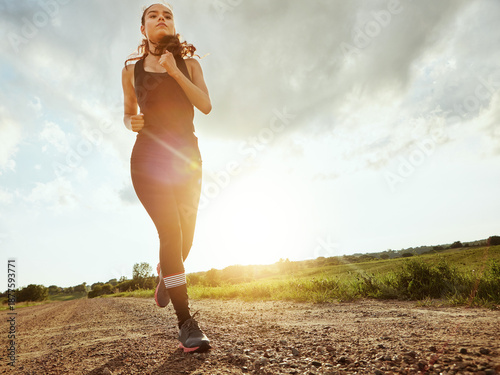 Below, running, and space with woman in countryside for cardio, challenge or health activity. Exercise, fitness and flare with athlete or runner outdoor in nature for training or workout routine