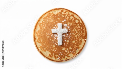 Golden pancake with powdered sugar cross on white, symbolizing religious origin of pancake day and shrove tuesday traditions