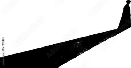 Silhouette of a lone figure in cloak with long shadow