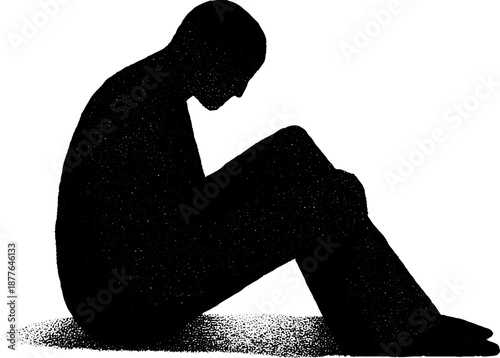 Silhouette of a sitting figure in pensive pose reflecting solitude