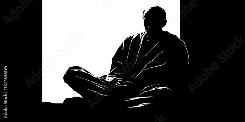 Silhouette of a male in meditation pose