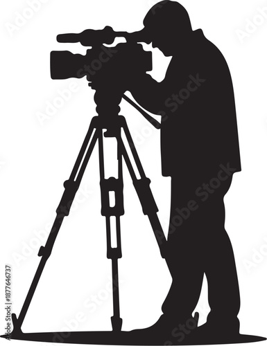 Silhouette of a man operating a large video camera