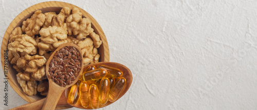 Heart shaped composition of omega 3 supplements and natural food sources on light background