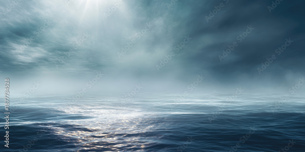 Obraz premium Misty ocean surface with sunlight streaking through hazy clouds