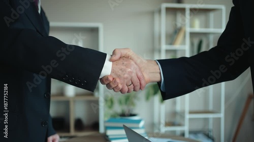Close-Up of Senior and Middle Aged Businessmen Shaking Hands