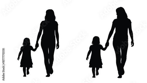 Two mothers and their daughters walking hand in hand in silhouette