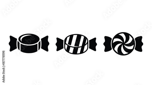 A simple illustration of four black and white spiral wrapped candies