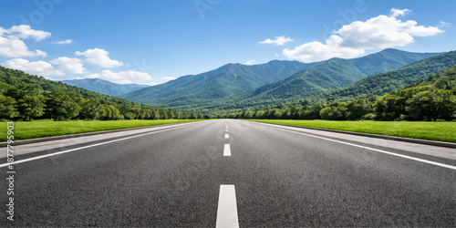 Open road landscape with mountain scenery and fresh green forest surroundings