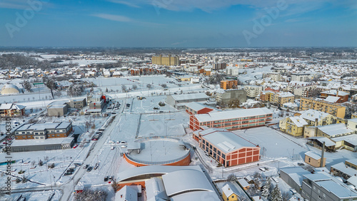 Drone footage of the city panorama and houses covered in snow