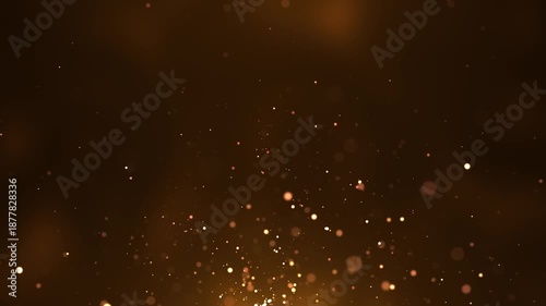 abstract animated concept featuring golden particles rising upwards for birthday and holiday celebrations. A looping 4K background with a bokeh effect and glowing particles against a dark background.