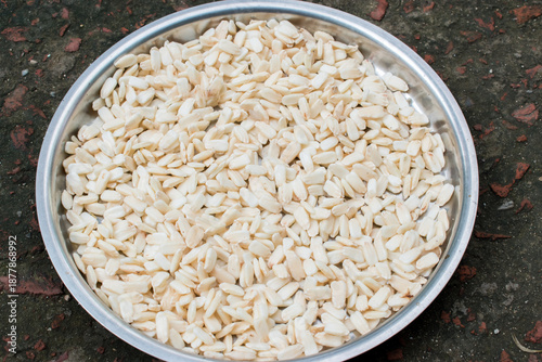 drying bottle gourd seeds in a plate under sun.  