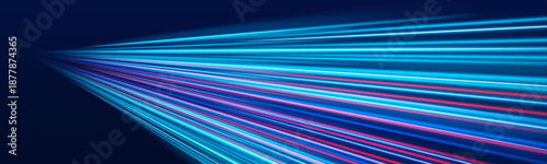 Futuristic blue, purple neon laser streaks curve along a dark city road at night. Glowing motion violet trails, energy swirls, and wave lines show high-speed traffic flow. Vector illustration.
