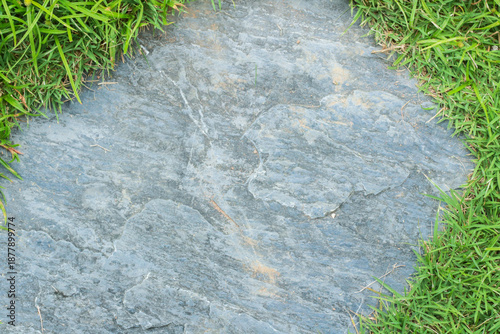 Close-up view of granite laid on grass lawn, creating a natural