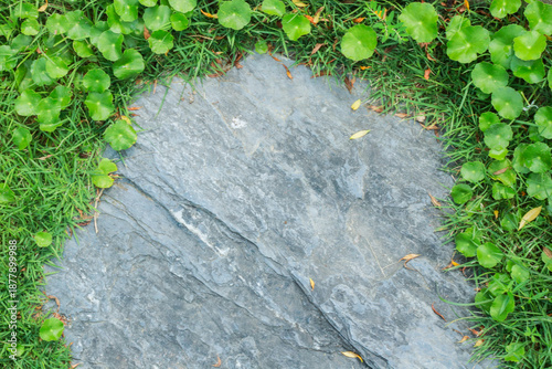 Close-up view of granite laid on grass lawn, creating a natural