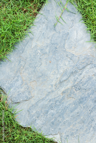 Close-up view of granite laid on grass lawn, creating a natural