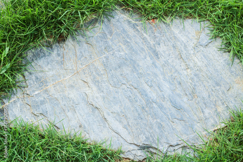 Close-up view of granite laid on grass lawn, creating a natural