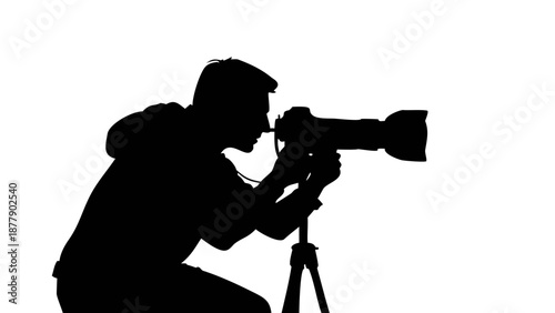Silhouette of a photographer holding a professional DSLR camera with a tripod, taking a photo, media and creativity concept.