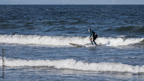 Canvas Print Surfers who ride the wind and waves, surfing forward on the waves