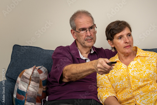 Older couple on the couch looking at tv together
