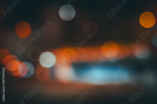 Abstract night bokeh lights through glass background