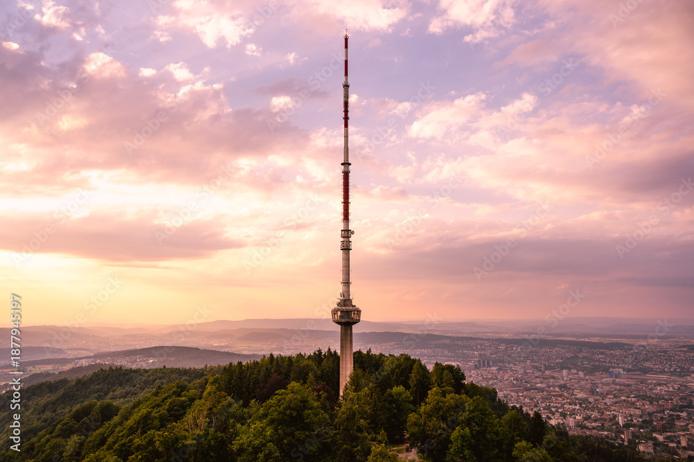 Obraz premium Zurich Switzerland Uetliberg telecommunications network broadcasting antenna tower station with colorful clouds during sunset 
