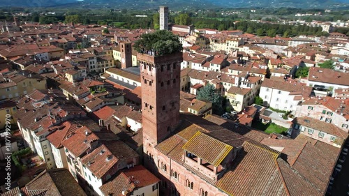 Cinematic Orbit Flight around Guinigi Tower: Iconic Medieval Brick Tower with Holm Oaks on Top, Lucca Tuscany Italy