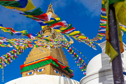 Kathmandu, Nepal. Swayambhunath Buddhist stupa. Large spherical stupa in capital of Nepa, World Heritage. Colorful Tibetian prayer flags on the top of stupa with Buddha eyes. Swoyambhu Mahachaitya