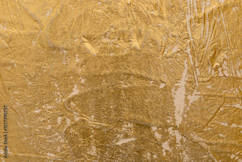 Close-up view of a golden textured Venetian plaster surface showcasing intricate patterns, ideal for backgrounds, design inspiration, or adding an elegant touch to visual projects.