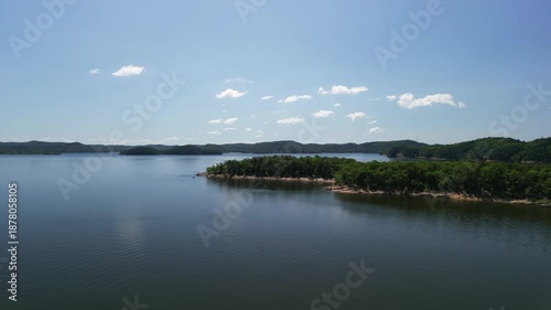Drone video of lake panorama with islands and forested shore calm water summer landscape slowly flying forward above lake