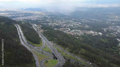 Stunning Aerial View of Simon Bolivar Avenue in Quito, Ecuador with Urban Traffic and Mountain Scenery