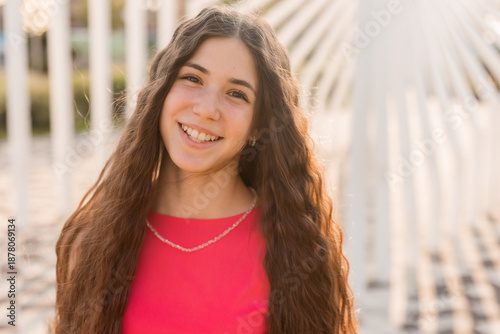 beautiful teenage brunette girl with long hair, smiling, looking at the camera during a summer walk Free Download beautiful teenage brunette girl with long hair, smiling, looking at the camera during a summer walk - GFXLoad