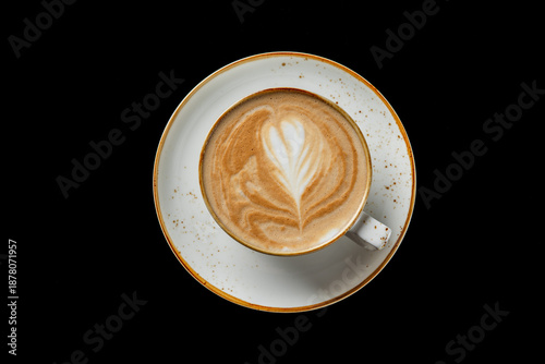 Bild auf Leinwand A top-down shot of a cappuccino or latte in a rustic ceramic cup and saucer, fea