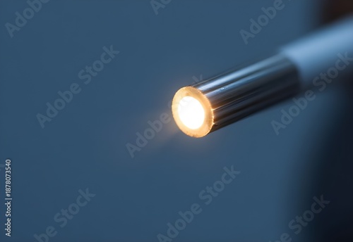 A bright electric flashlight object with a glass bulb shines a spotlight of light against a dark blue and black background design