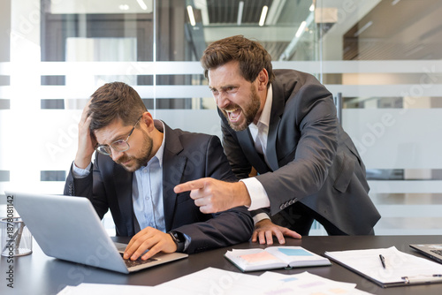 Foto Stressed employee with head in hand experiences workplace harassment from shouti
