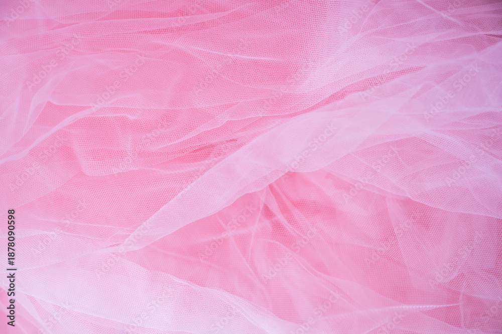 Fototapeta premium Abstract background of soft pink tulle fabric. Delicate mesh texture for wedding, bridal, or romantic feminine designs