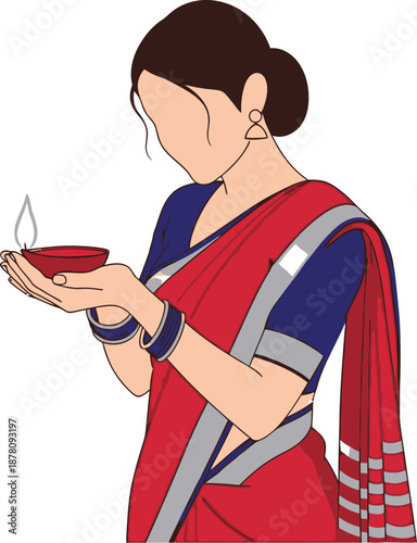 Young woman holding small lit diya lamp wearing traditional indian red and blue saree dress for religious festival celebration