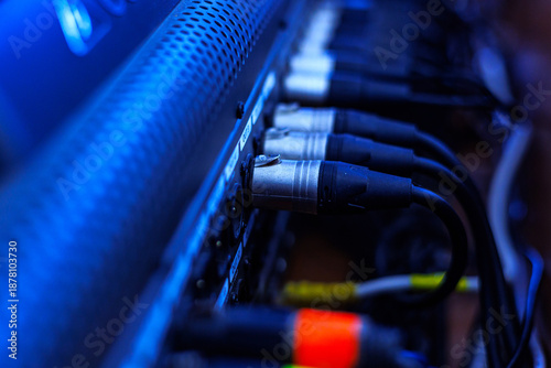 Rear console of control panel for equipment with connection cables to connect the equalizer, amplifier, microphones, speakers and other musical instruments. Connections of professional sound system.