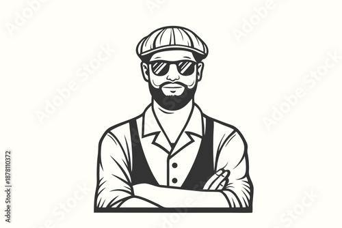 Bearded man wearing a cap and sunglasses has his arms crossed across his chest