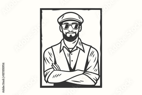 Bearded man with sunglasses and cap in frame stands confidently with his arms crossed