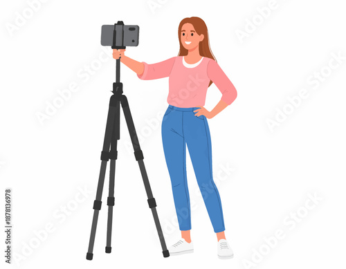 Young woman recording video with smartphone on tripod, smiling.