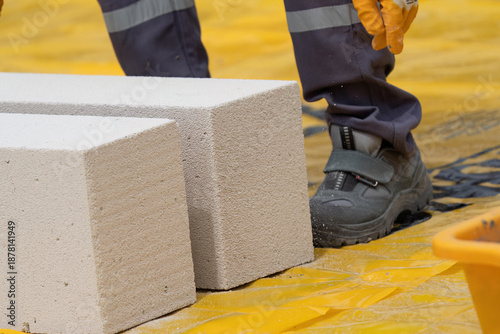The bricklayer is working. Building a wall of aerated concrete. Gasbeton wall